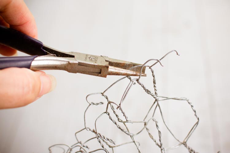 folding uneven edges under with pliers