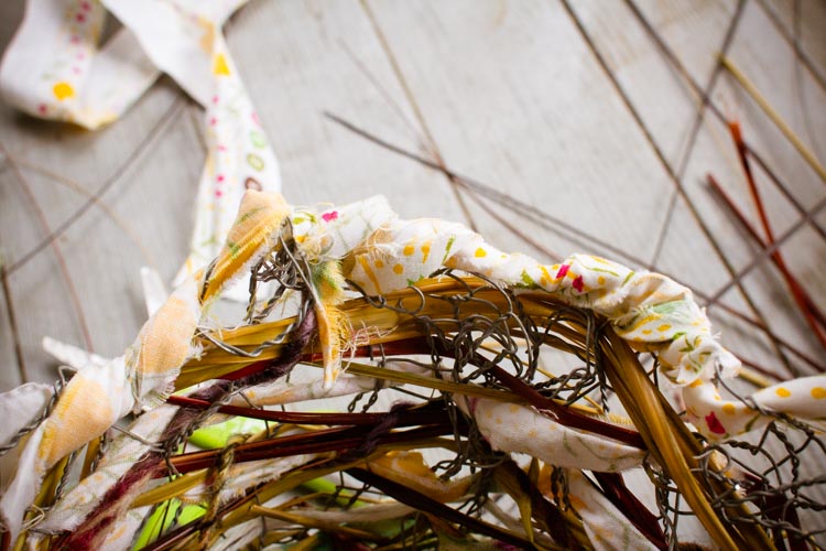 weaving fabric around the top edge to enclose