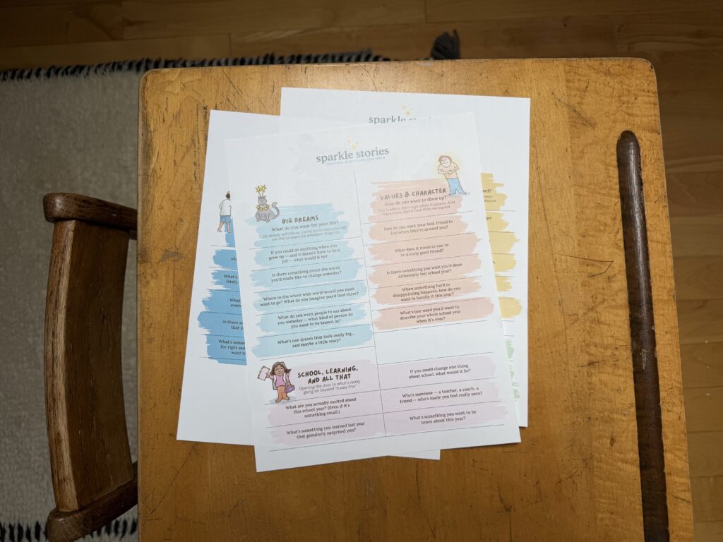 Photograph of the Sparkle Stories printable Conversation Starter Cards sitting on a school desk.