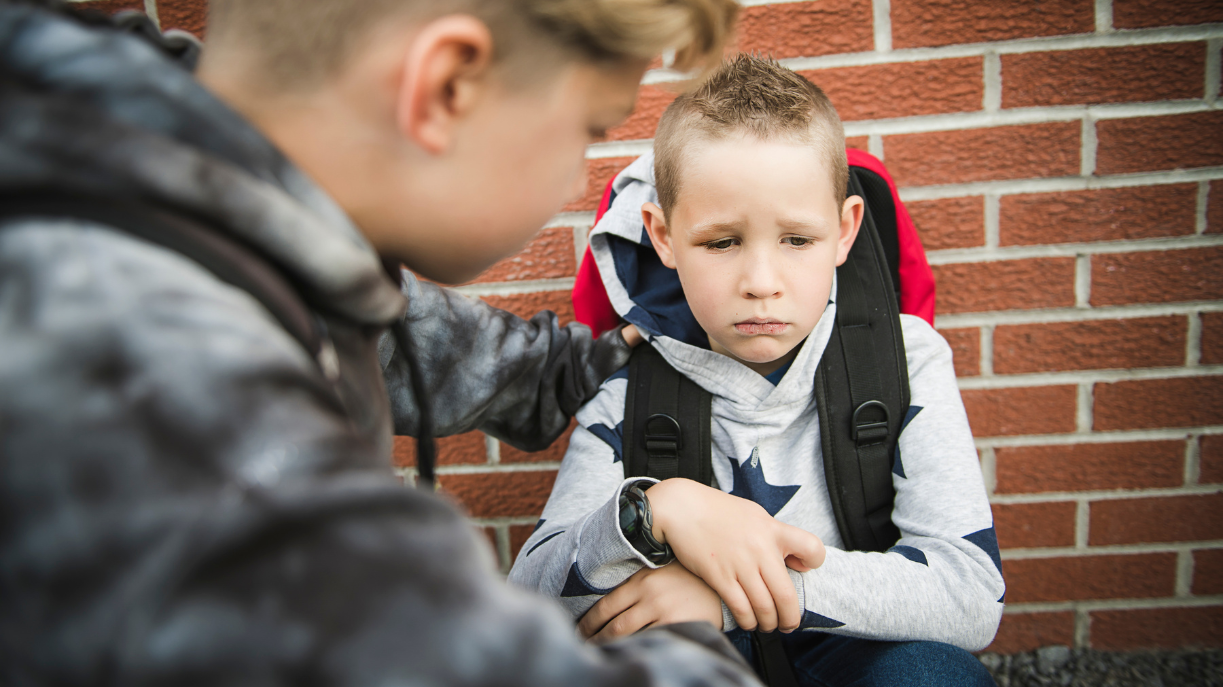 child comforting another child
